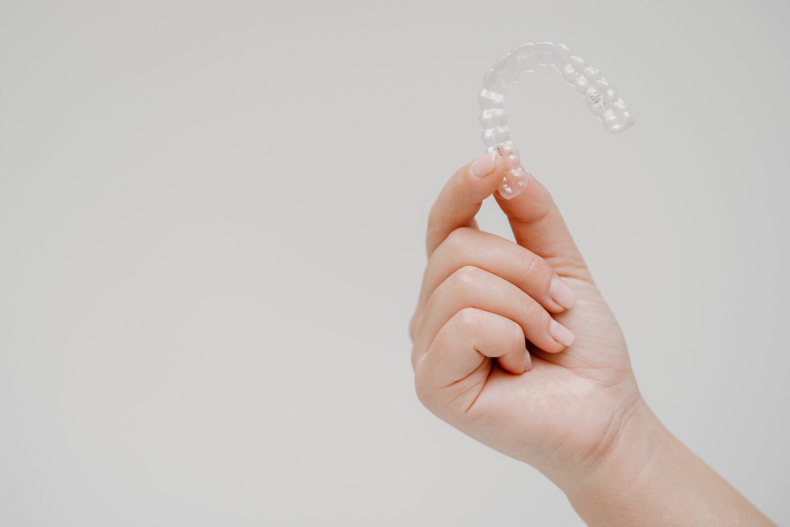 Transparente Alignerschiene in der Hand einer Kollegin der Praxis MAX 36